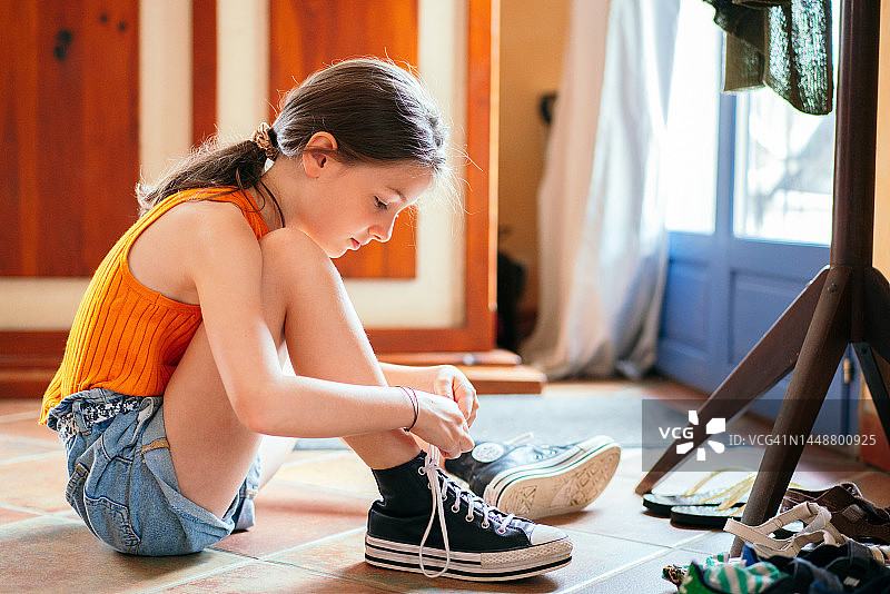 小女孩在家学习系运动鞋图片素材