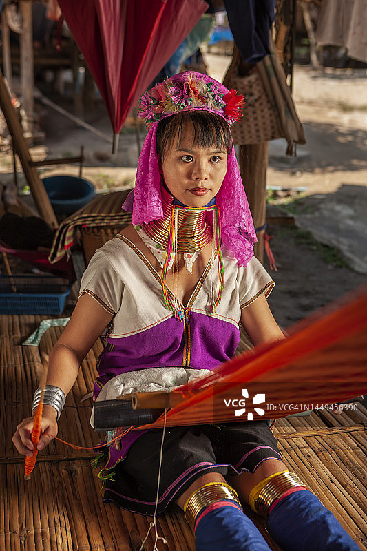 长颈喀伦族年轻女子在传统织布机上编织图片素材