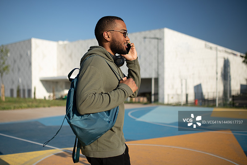 非裔美国男子一边打电话一边去锻炼图片素材