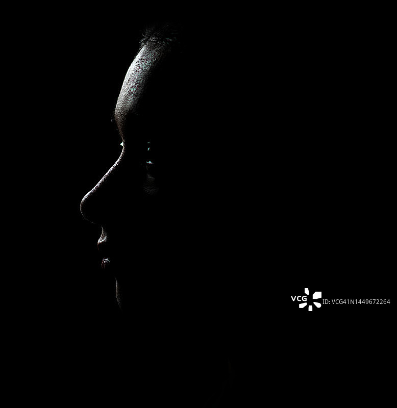 阴影中的年轻女子侧面照图片素材