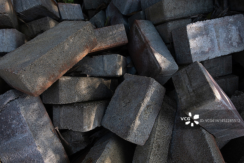 人行道上的建筑材料：红色旧砖库存，用于建造地基的多孔红色陶瓷砖。图片素材