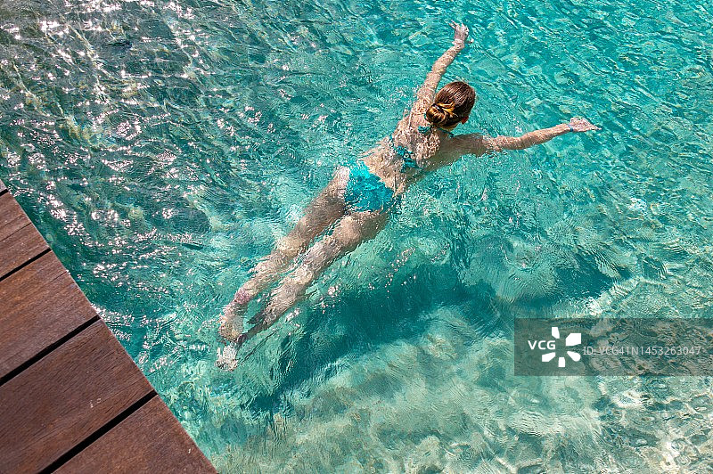 毛里求斯泳池中游泳的女孩（高角度拍摄）图片素材
