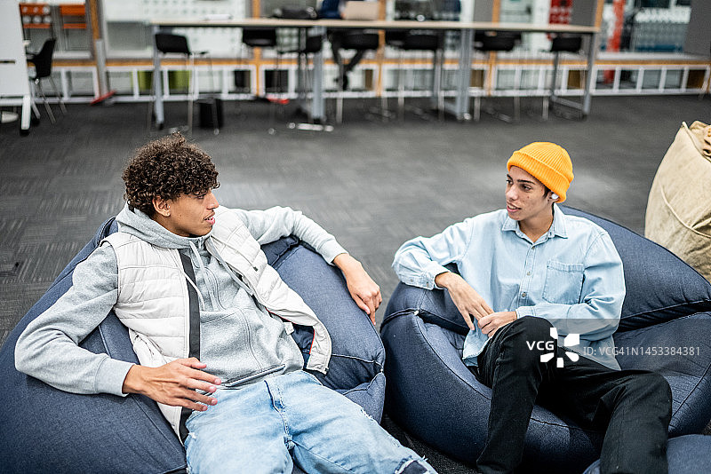 大学课间休息时交谈的年轻男学生图片素材