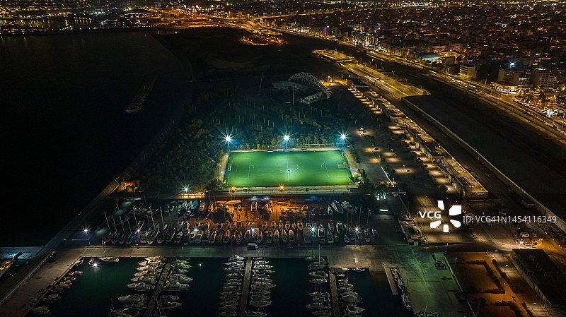 码头旁边的照明足球场夜间航拍照片图片素材