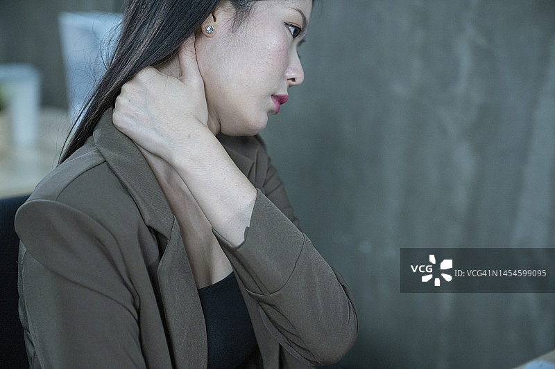 办公室里坐在椅子上脖子疼的商务女性图片素材