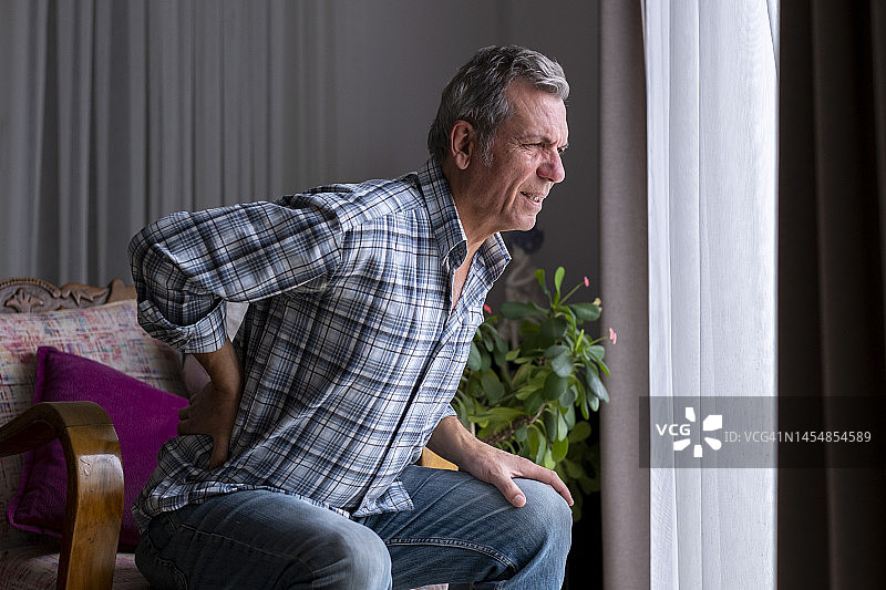 年长男人的手放在他的背上，背痛图片素材