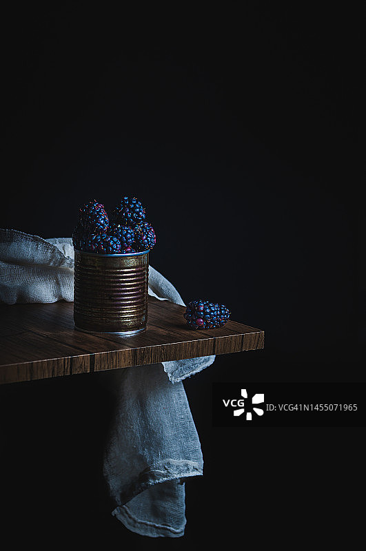 深色背景木桌锈锡中大黑莓照片，留白图片素材