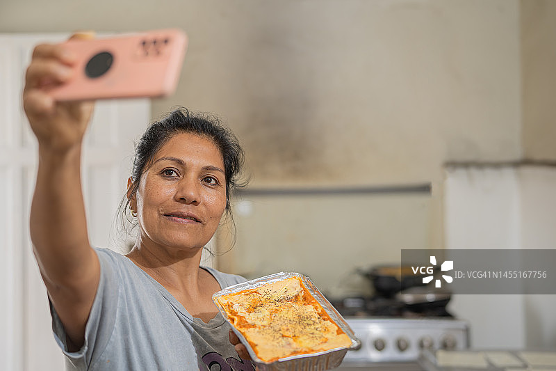 女人与自制千层面合影图片素材