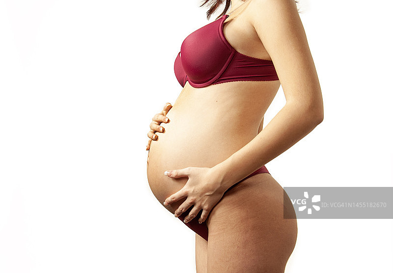 触摸腹部的年轻孕妇图片素材