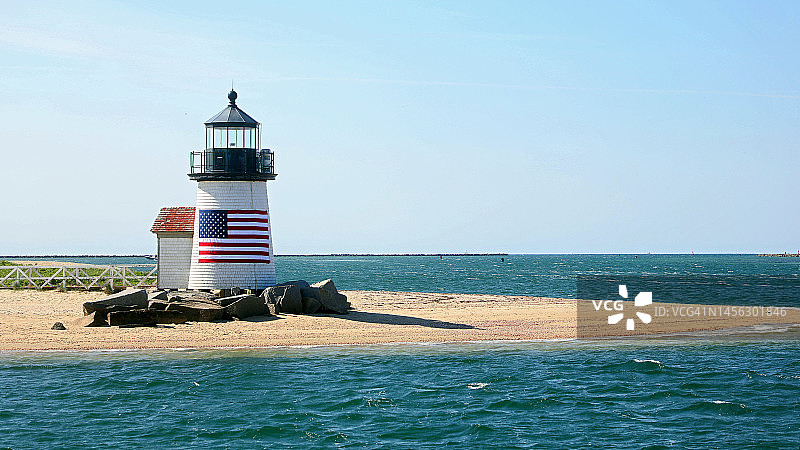 玛莎葡萄园岛海滩上飘扬着美国国旗的灯塔图片素材