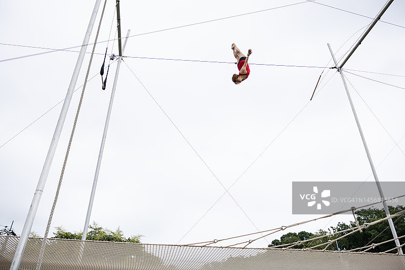 在空中飞翔的中年杂技演员图片素材