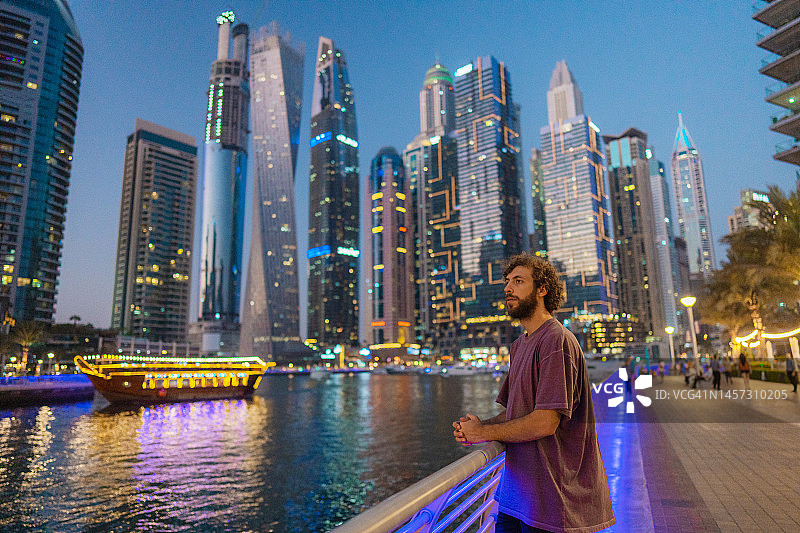 日落时分，男人走在迪拜码头图片素材