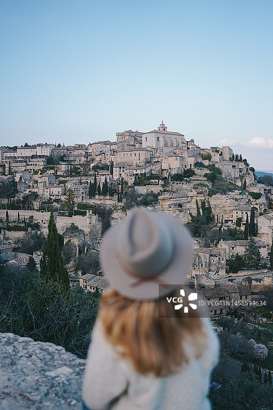 眺望山顶村庄的年轻女子图片素材