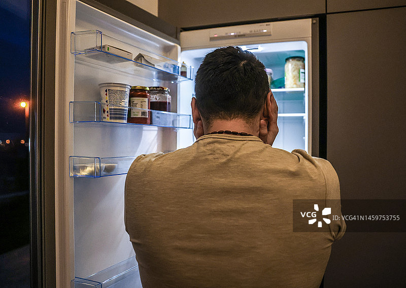 冰箱前的沮丧男人图片素材