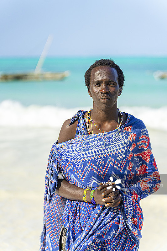 站在田园诗般海滩上的马赛男人看着镜头图片素材