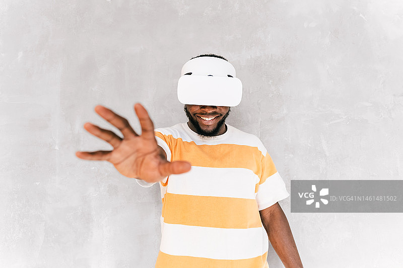 快乐的非裔美国男人在元宇宙未来世界中使用VR眼镜图片素材