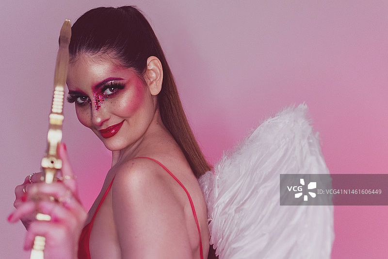 女人扮演丘比特天使手持弓箭爱心图片素材