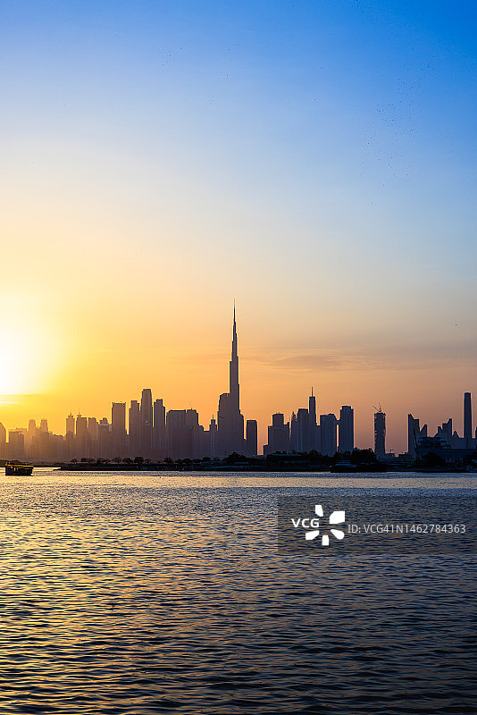 阴天时从湖边看到的迪拜城市天际线图片素材