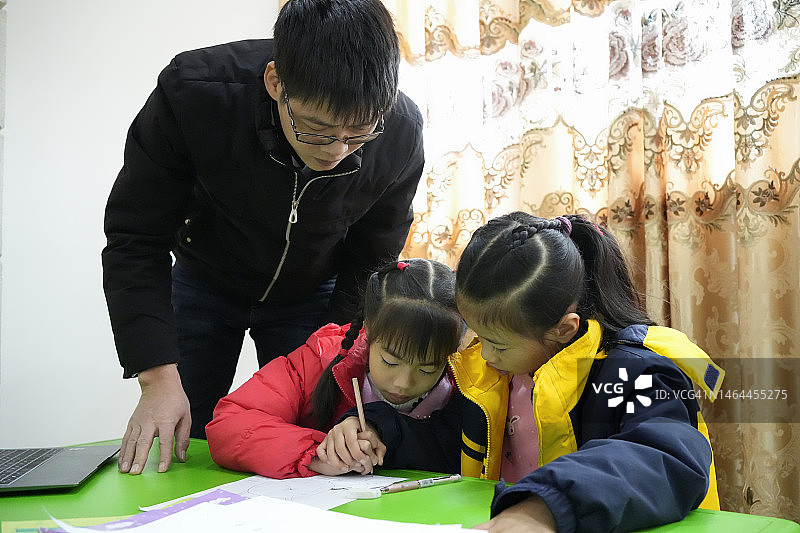 小学生互相传纸条完成老师的作业图片素材