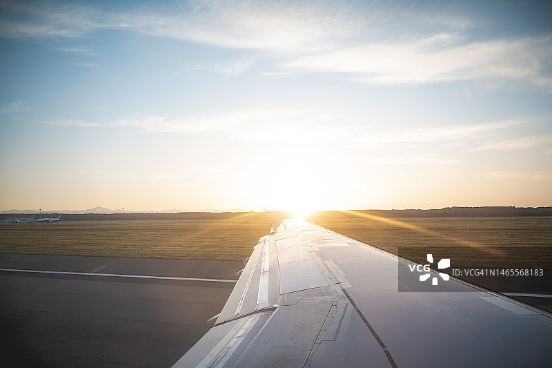 日落时分在跑道上的飞机视角图片素材