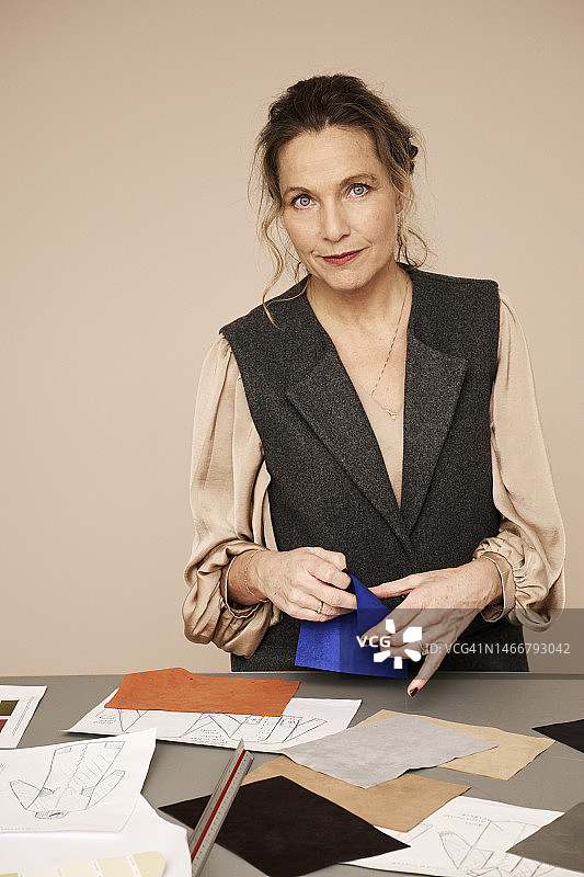 站在办公室桌旁的微笑设计师图片素材