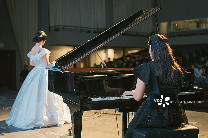 中国钢琴家与女歌唱家在舞台上表演图片素材