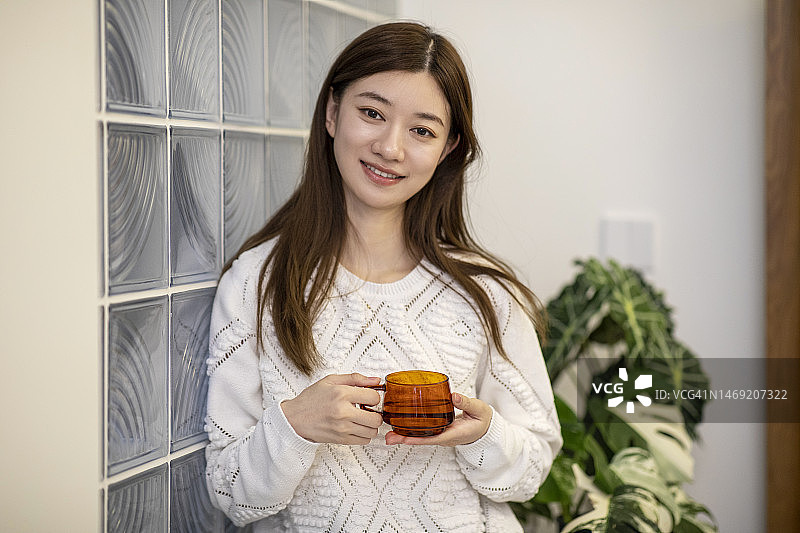 微笑女人客厅饮水肖像图片素材