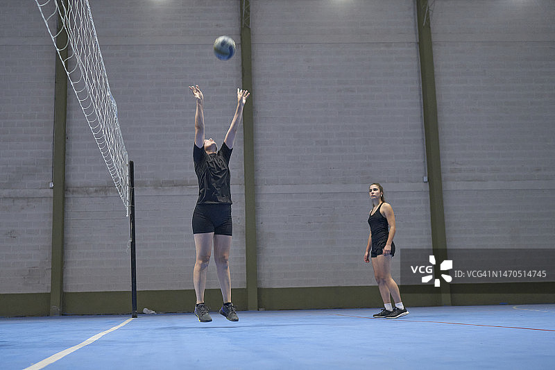 跳起踢球的排球女子图片素材