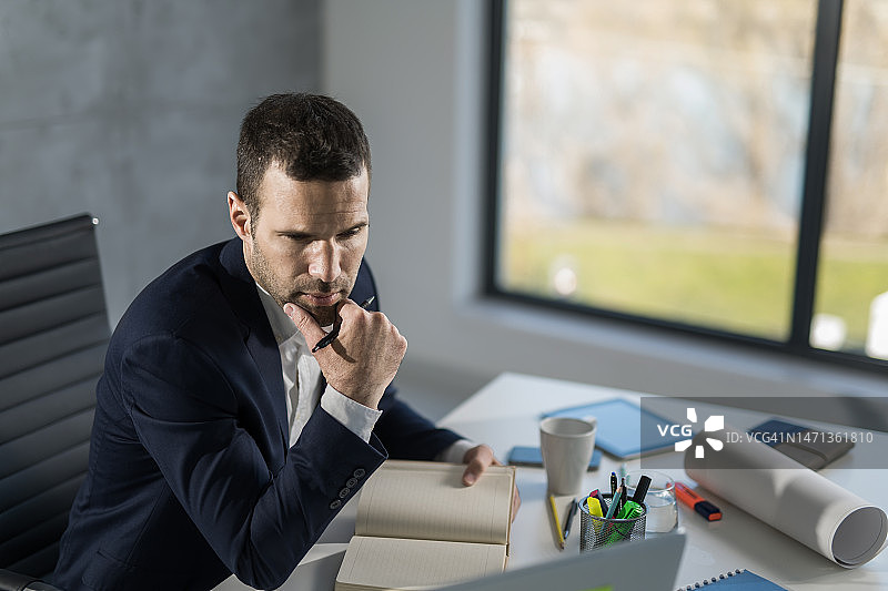 在办公室使用笔记本电脑的商人图片素材