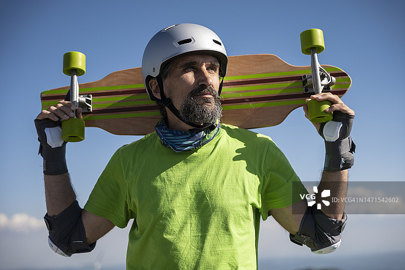 蓝天背景下的中年男人与长板图片素材