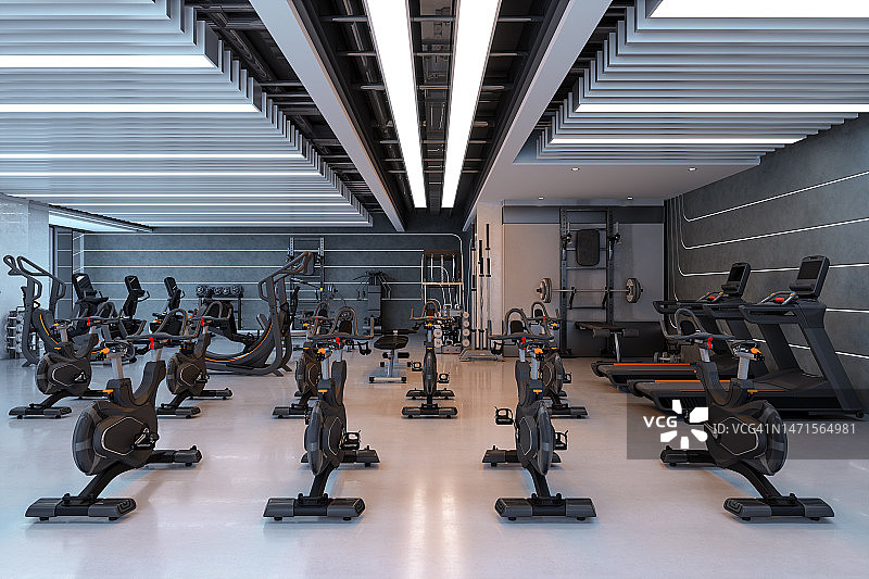 配有动感单车、跑步机和运动器材的现代健身房内景图片素材