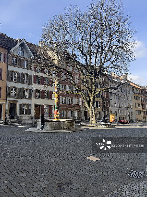 瑞士比尔老城天使喷泉雕塑前的女人图片素材