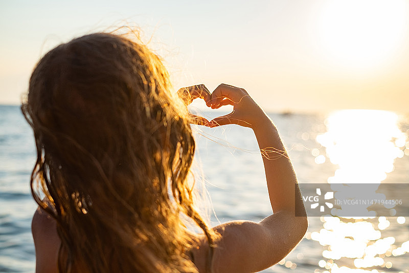 小女孩用手比心图片素材