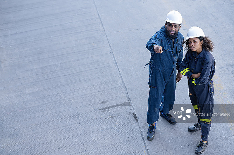男性物流工程师在货运场讨论集装箱装载图片素材