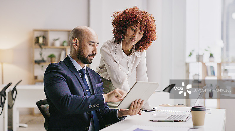 商务人士在办公桌使用平板电脑进行数字营销或广告设计图片素材
