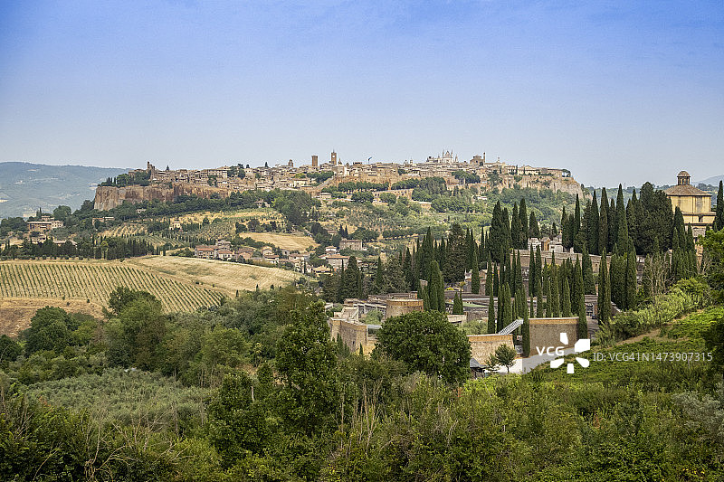 阳光明媚的蓝天下山丘上的城市，意大利奥尔维耶托图片素材