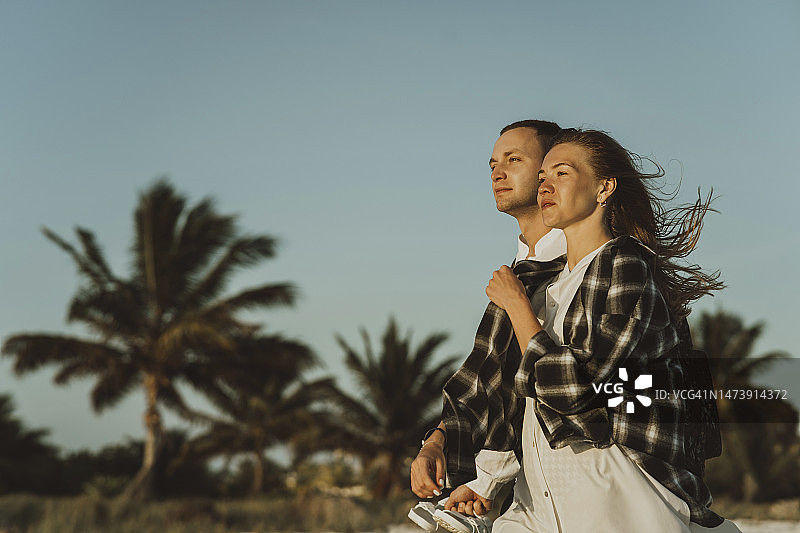 年轻情侣在黎明时分一起漫步图片素材