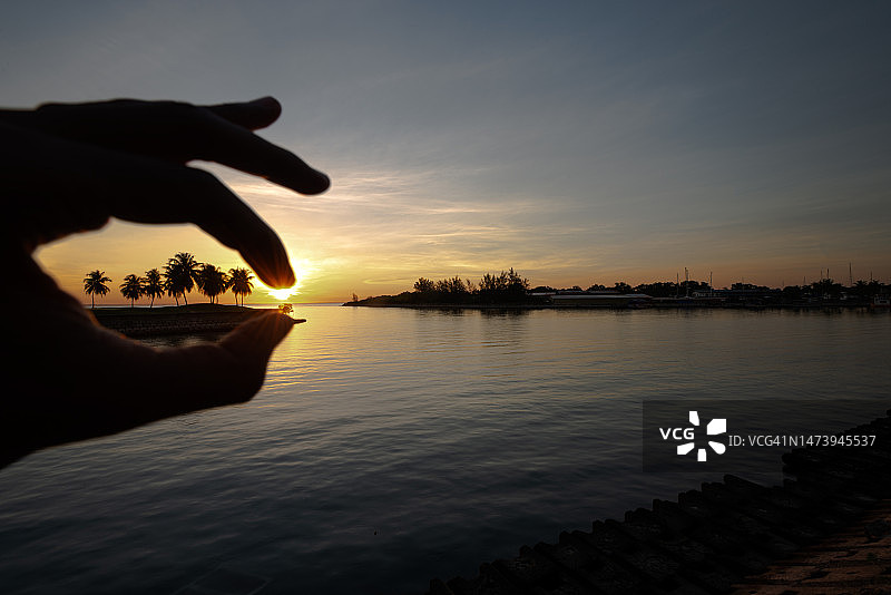 日落时分，手势剪影映衬天空图片素材