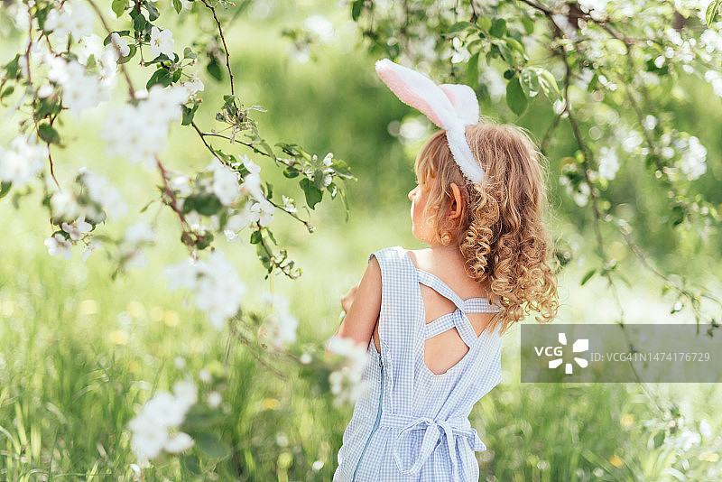 宝宝提着装满彩色复活节彩蛋的篮子图片素材