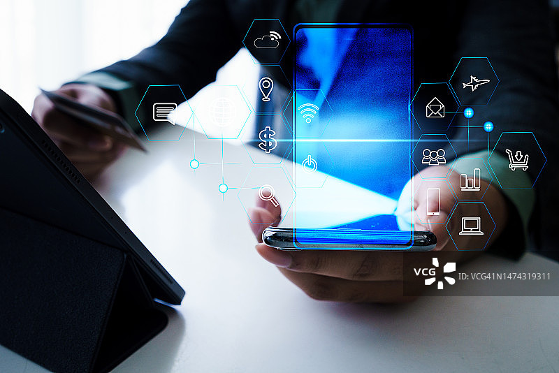 商人手持智能手机，展示手机图标界面图片素材