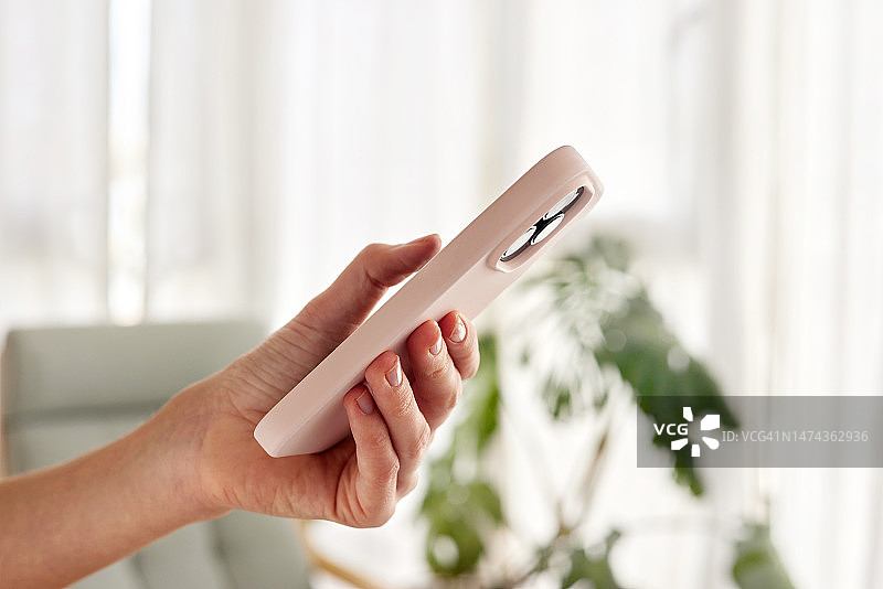 手持智能手机轮廓，背景虚化图片素材