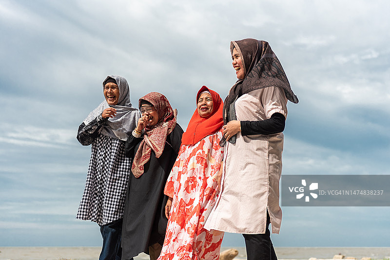 在海滩上行走的老年妇女图片素材