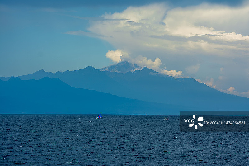 蓝色海洋上空的蓝色天空渐变山景图片素材