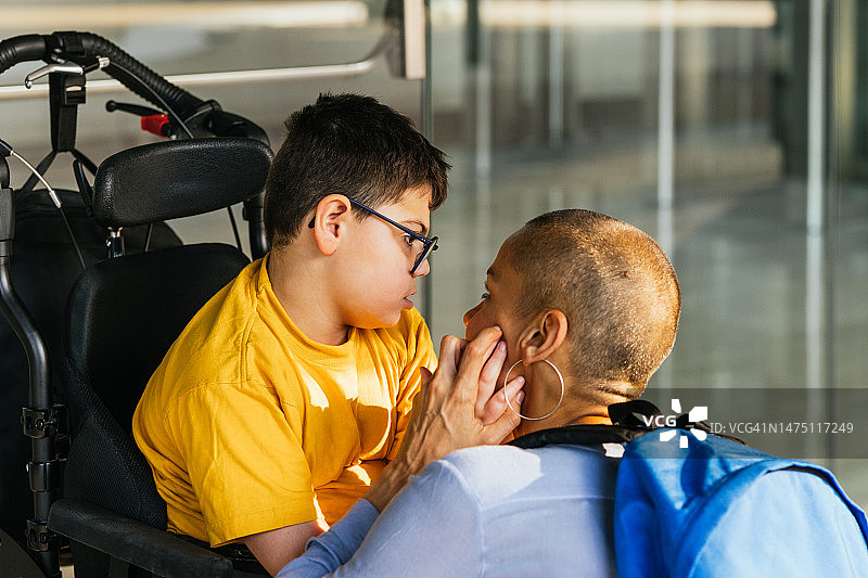 母亲带患有运动和智力障碍的儿子去诊所图片素材