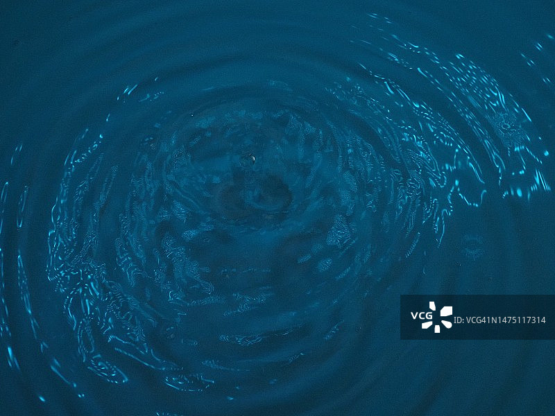 水滴和表面上的蓝色光图片素材