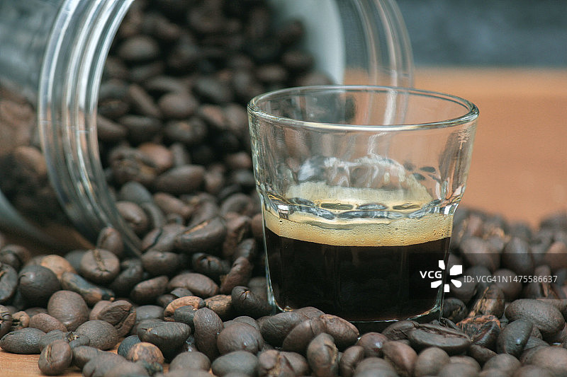 咖啡豆从桌上的容器中溢出的特写图片素材
