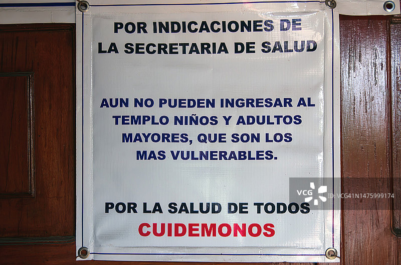 教堂门上的西班牙语标志：因健康原因，儿童和老人不得入内图片素材