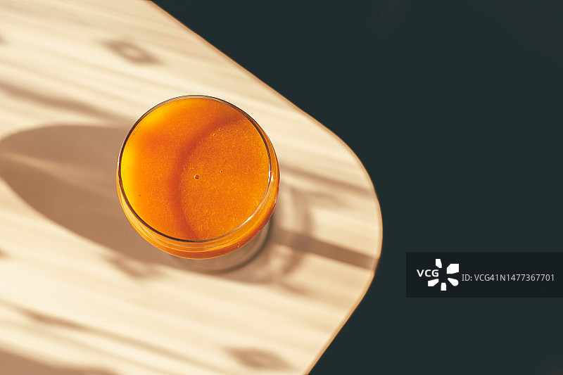 阳光照射下玻璃罐装新鲜杏汁，顶部留白图片素材