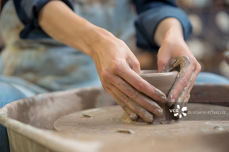 女人用陶轮制作陶瓷作品图片素材
