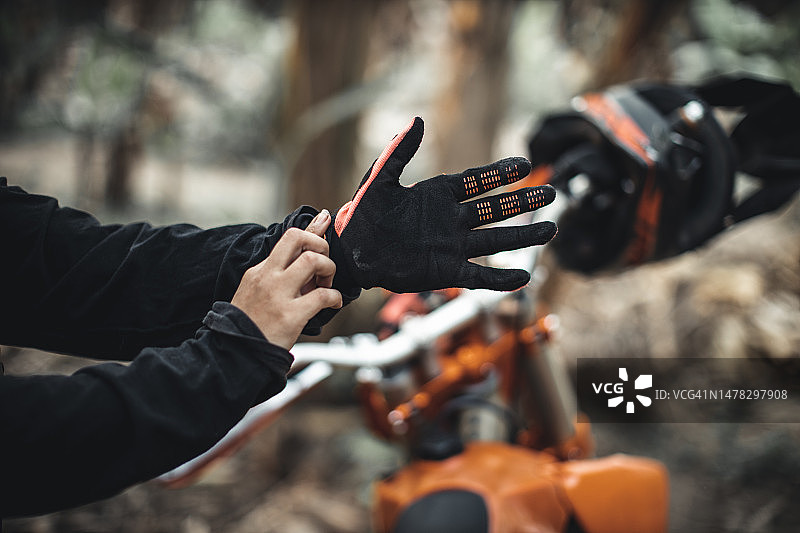 骑着越野摩托车穿越热带森林的年轻独立女性图片素材